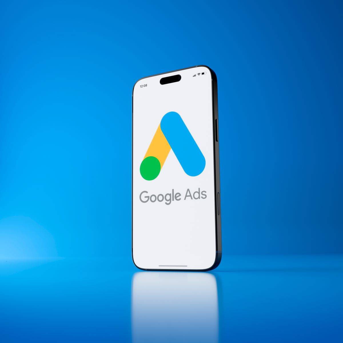 Smartphone displaying Google Ads logo on a blue background, emphasizing digital advertising and marketing strategies.